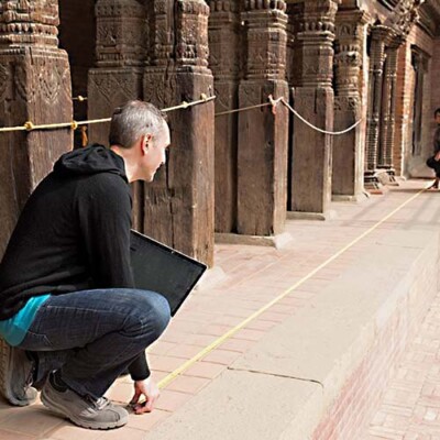 Greg Mitchell and Rajkumar Padasaini measuring a Patan Royal Palace-Art Museum Courtyard, 2-2016, photo by Eric Garrison
